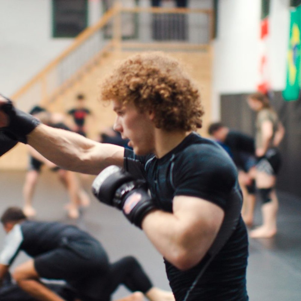 Adults training on the mats at Crossroads Martial Arts